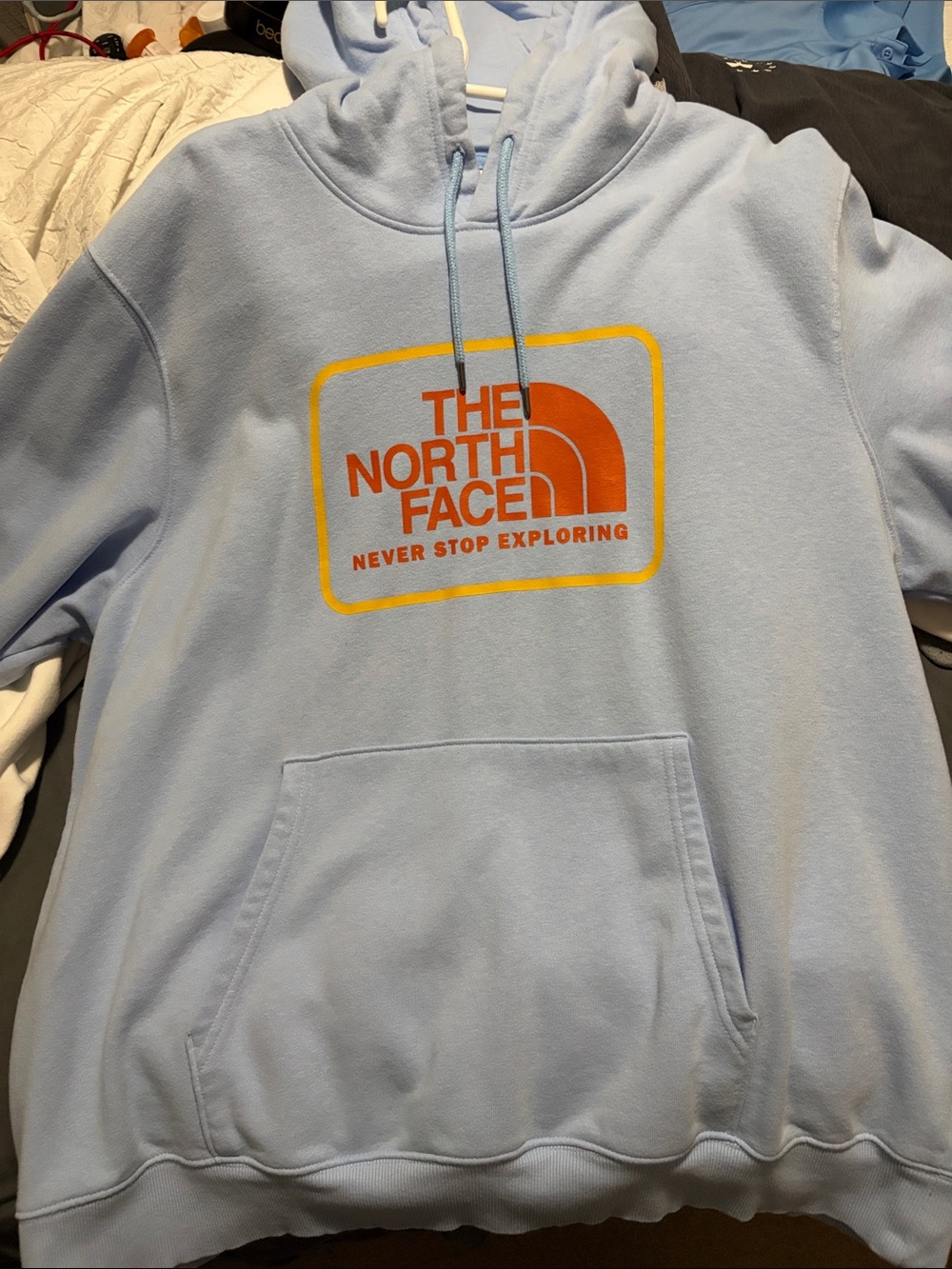 The North Face Light Blue Hoodie with Orange Logo and Yellow Trim